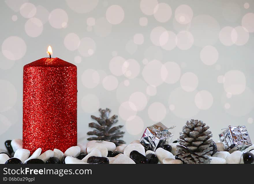 Christmas light with red candle, pinecones and gifts