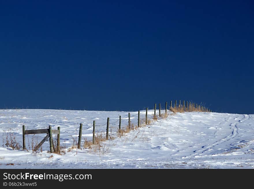 Fence line on snow covered ground