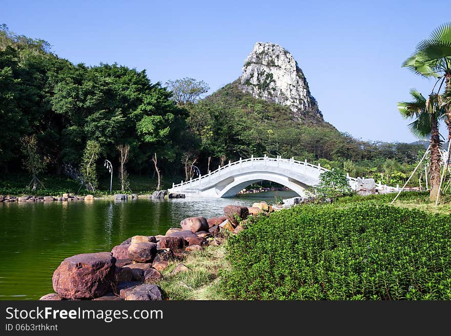 Chinese garden landscape:stone arch bridge and hill. Chinese garden landscape:stone arch bridge and hill