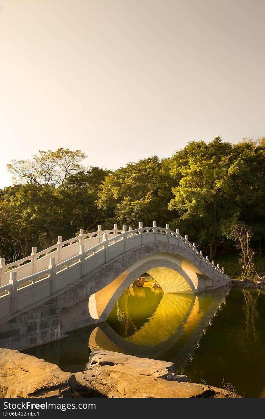 Chinese garden :A stone arch bridge in sunset. Chinese garden :A stone arch bridge in sunset