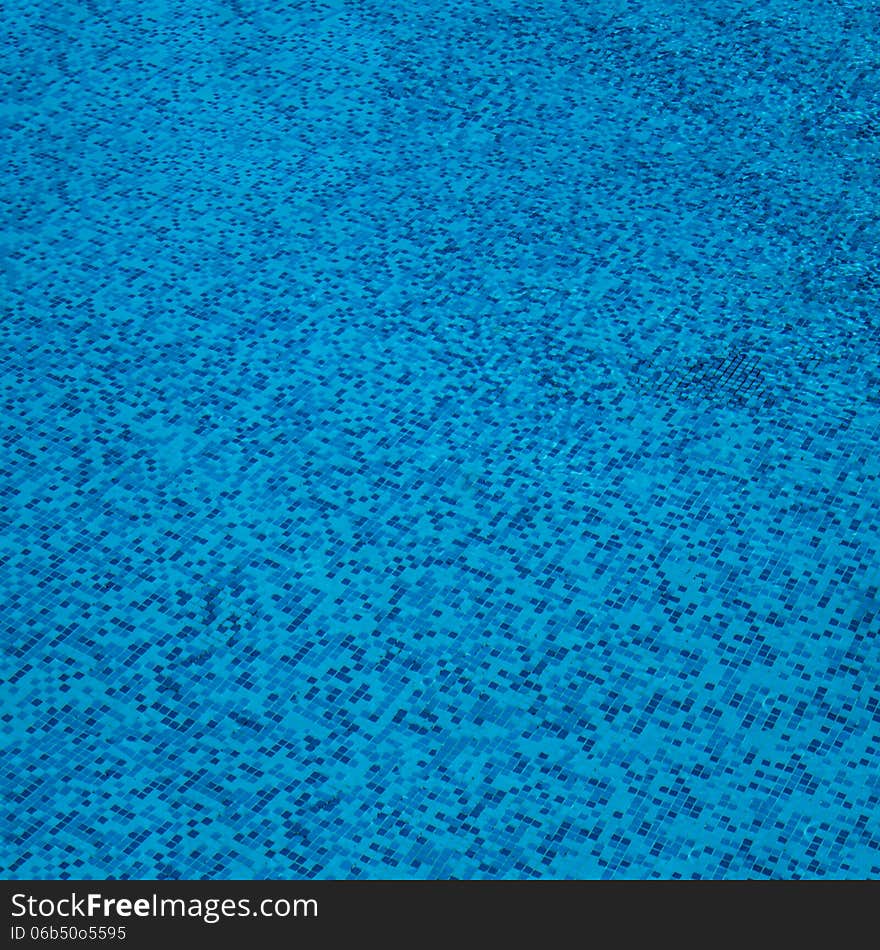 Bottom of the pool, tile texture background of swimming pool tiles, side view. Bottom of the pool, tile texture background of swimming pool tiles, side view