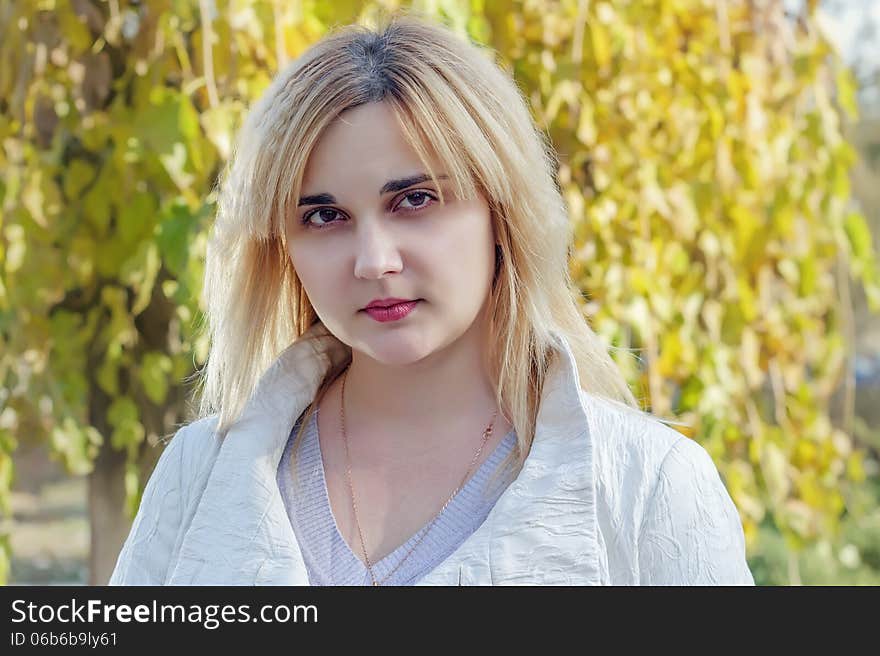 Portrait of a young woman in autumn park