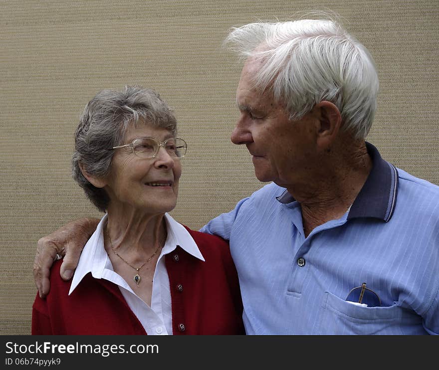 A devoted elderly couple share a quiet moment and a loving bond.