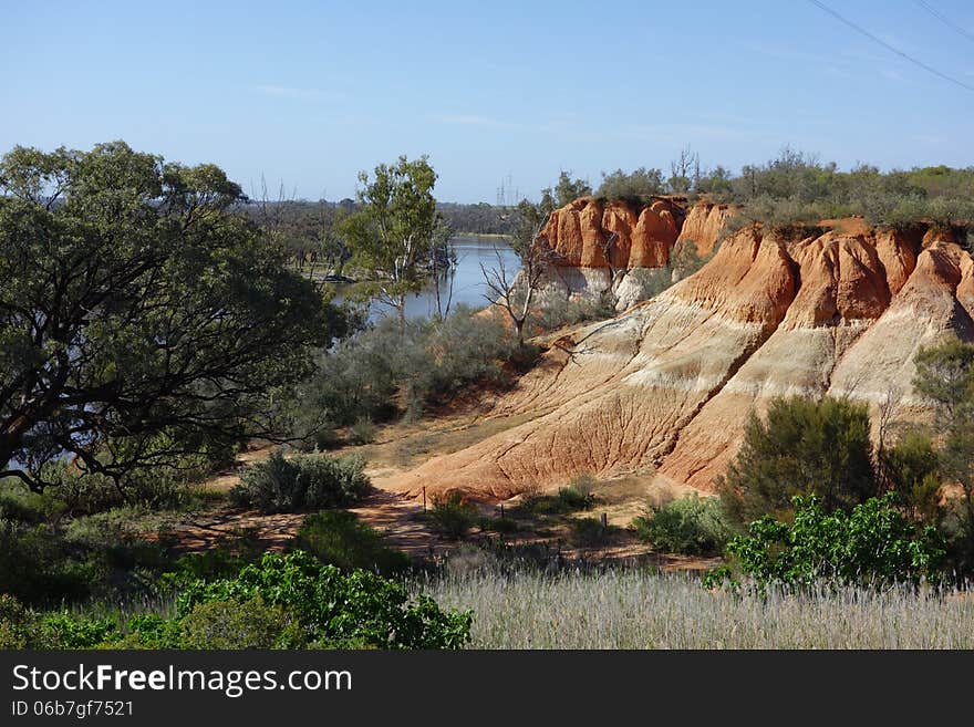 The Red Cliffs, namesake of the small town of Red Cliffs in North West Victoria, Australia. The coloured layers of rock compliment the surrounding green shrubs and blue river in the background.