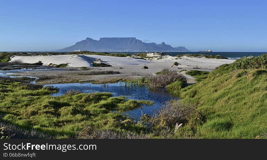 Landscape with sand dunes and Table Mountain