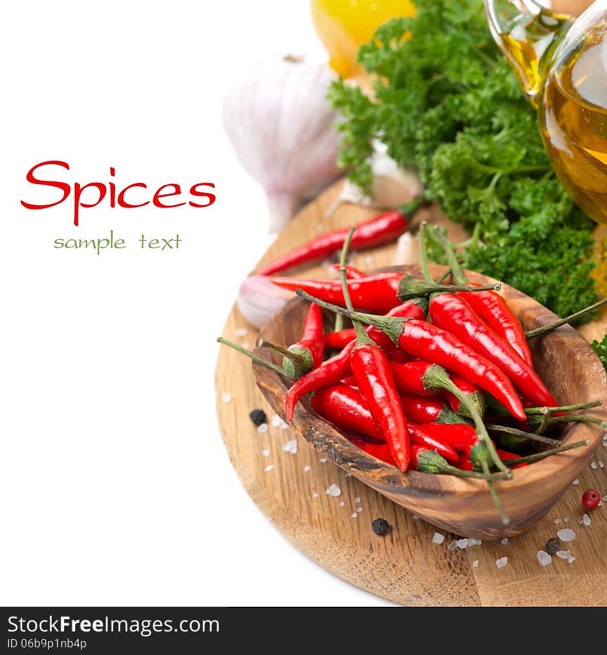 Fresh chili pepper garlic, spices and oil on a wooden board, isolated on white. Fresh chili pepper garlic, spices and oil on a wooden board, isolated on white