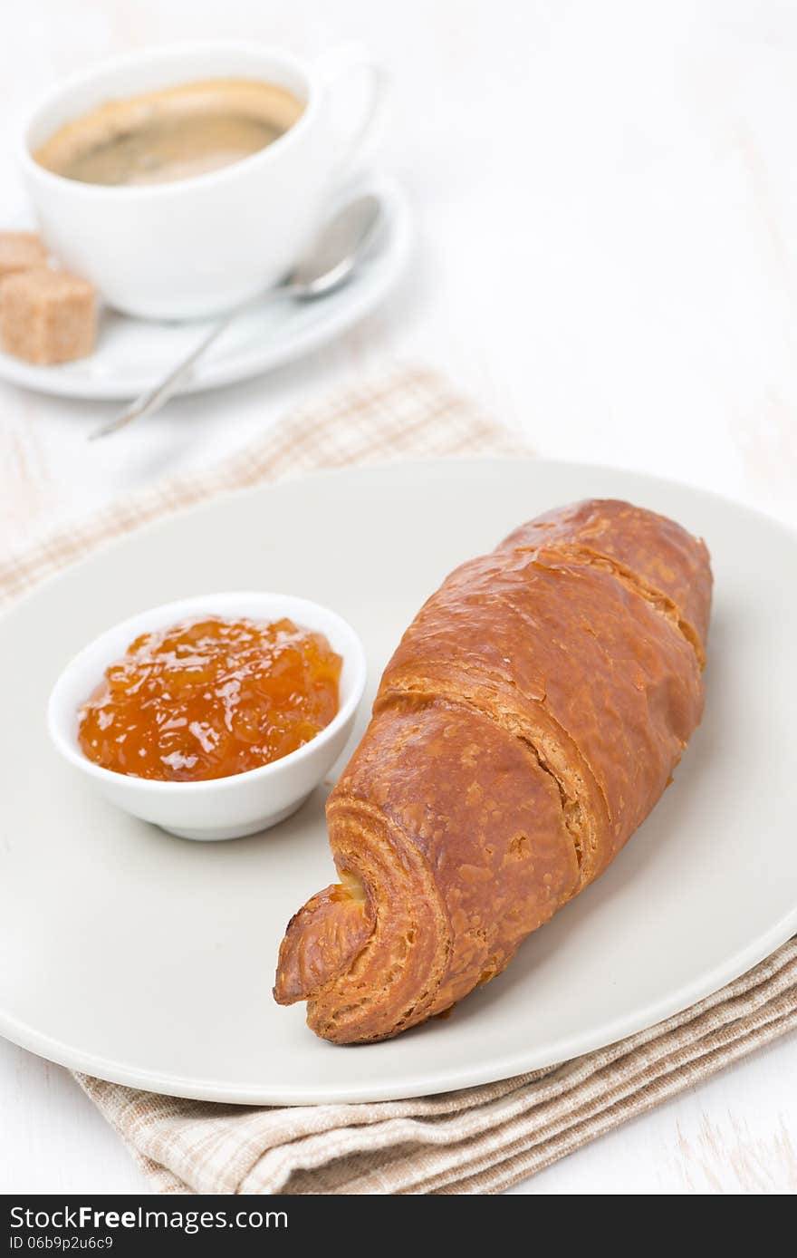 Fresh croissant with jam and coffee