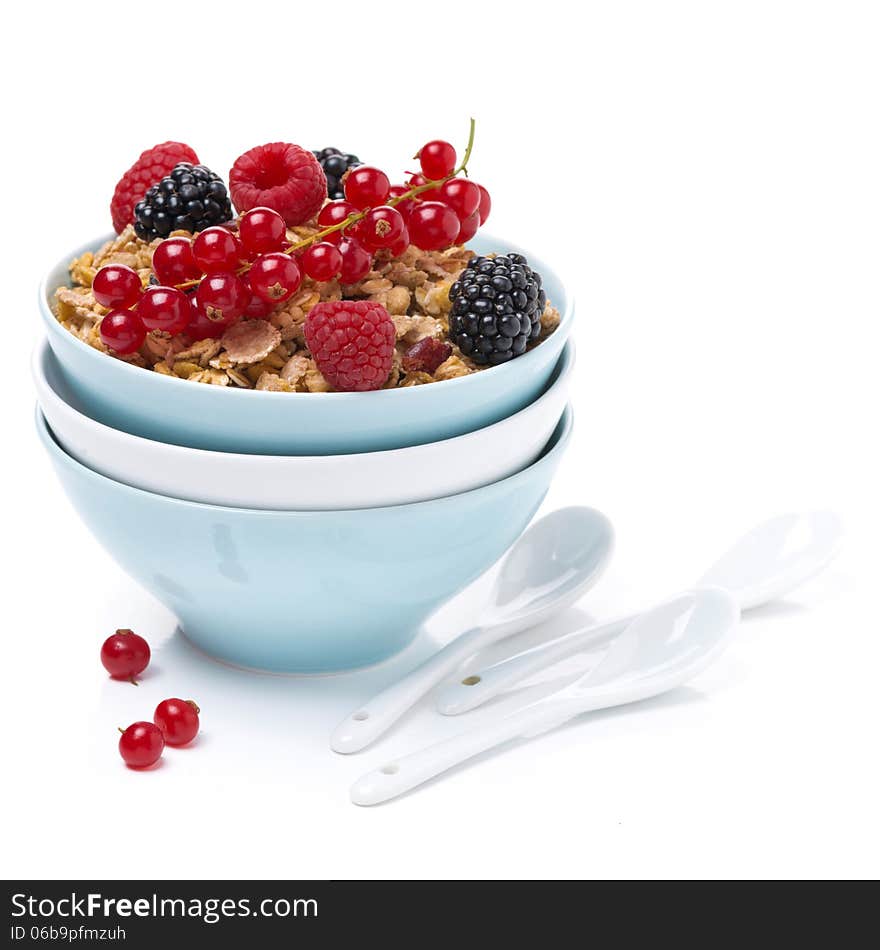 Homemade granola with berries in bowls and spoons,  isolated