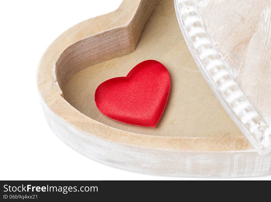 Red heart in a wooden box, isolated on white