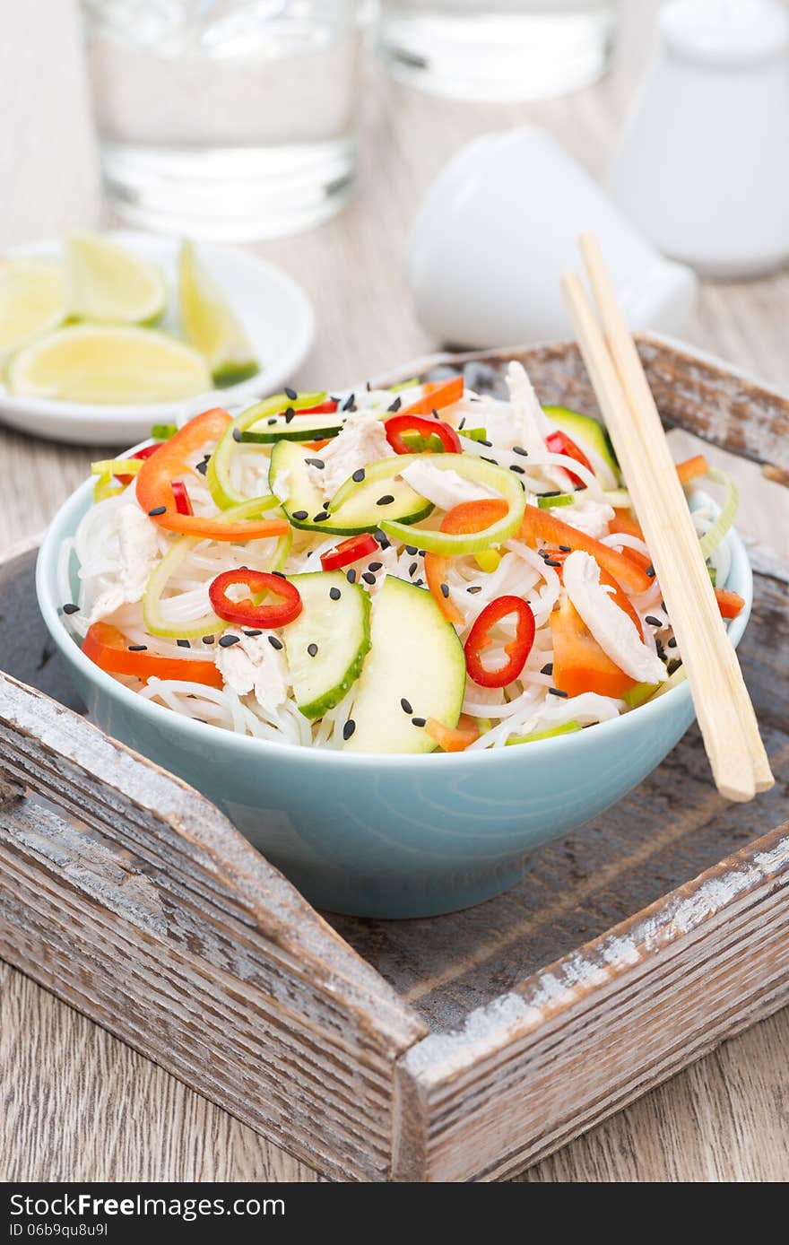 Thai salad with vegetables, rice noodles and chicken in bowl