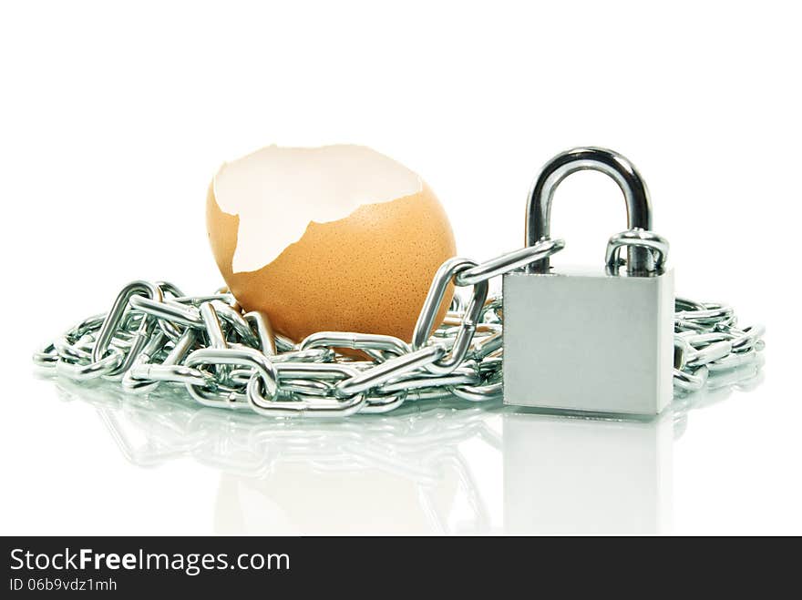 The shell of an egg, covered with a chain padlock