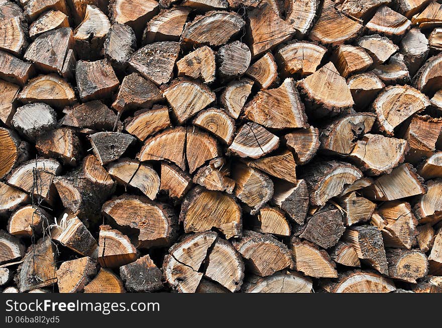 Background of stacked chopped wood prepared for winter