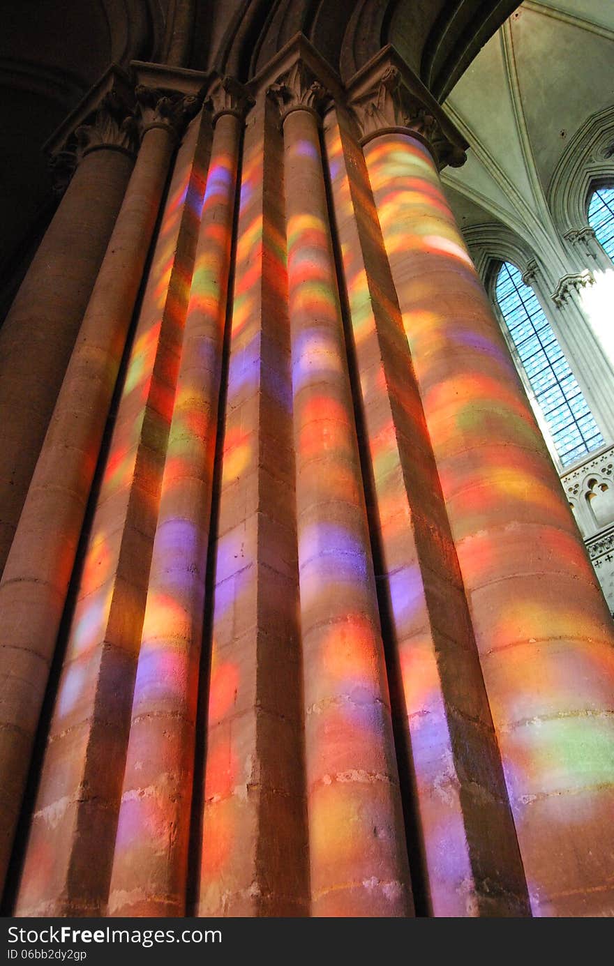 Bayeux Cathedral pillars lit through stained glass window, Normandy, France. Bayeux Cathedral pillars lit through stained glass window, Normandy, France