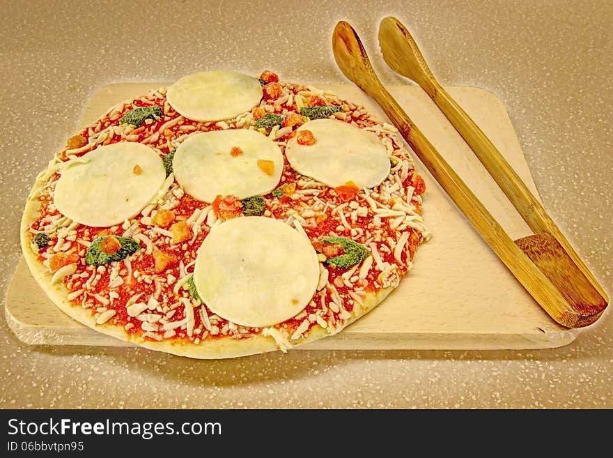 Mozzarella and spinach pizza in an oven
