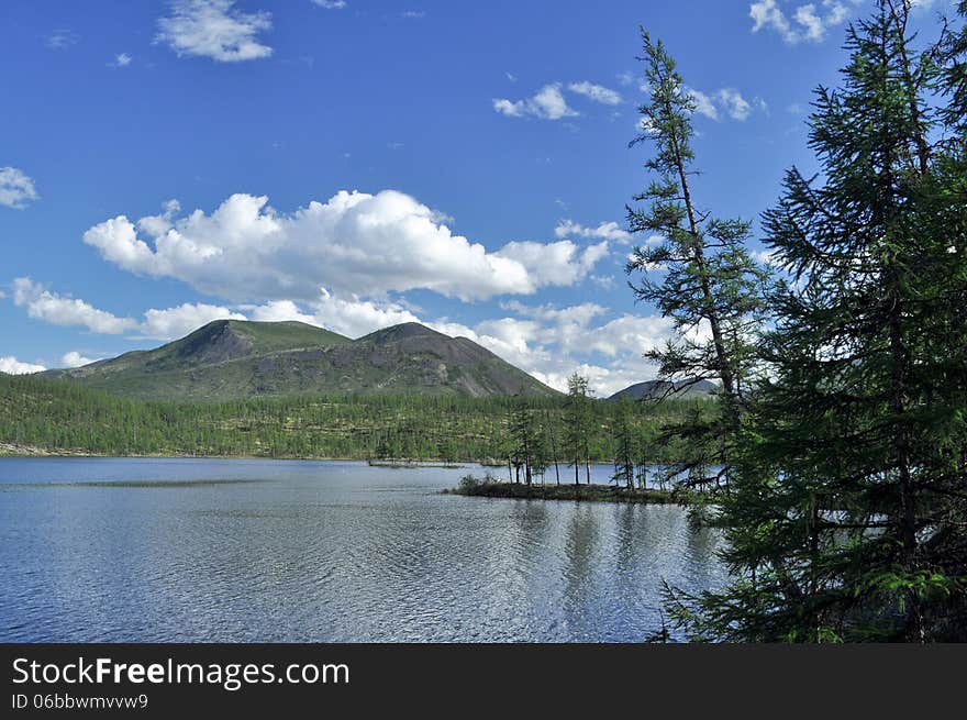 Landscape with a lake and mountains along the banks.