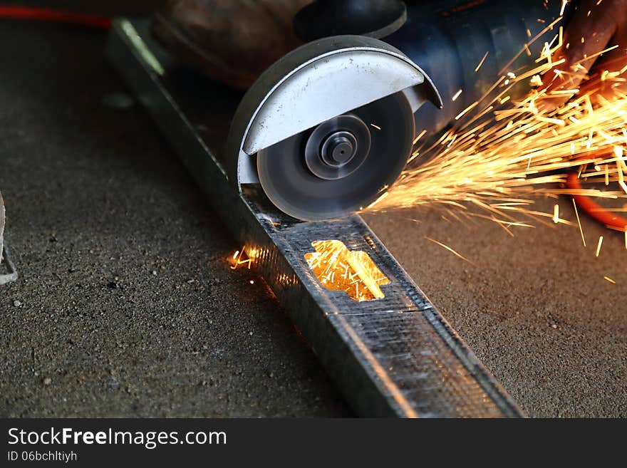 Worker using a metal cutter. Worker using a metal cutter