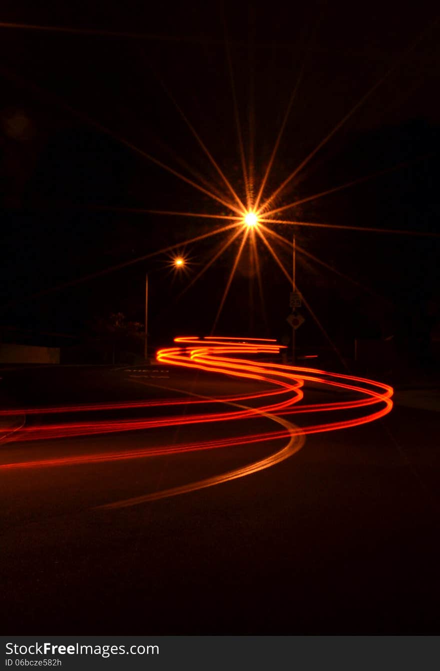 The lights of a car and street light at night