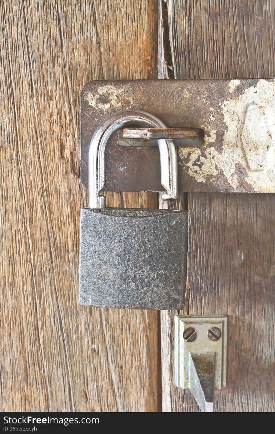 Old padlock on an old wooden door. Old padlock on an old wooden door