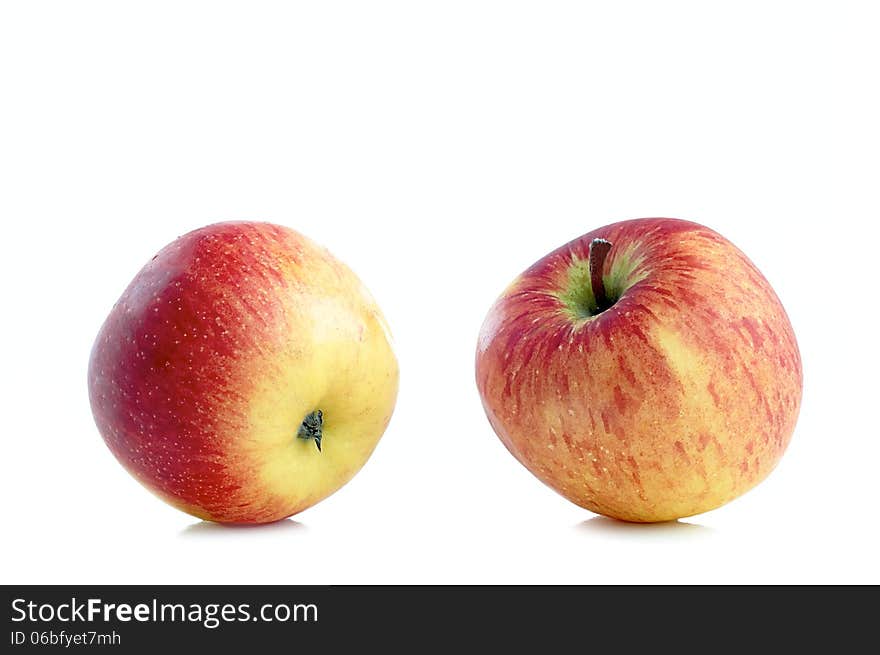 Two fresh sweet apples on a white background