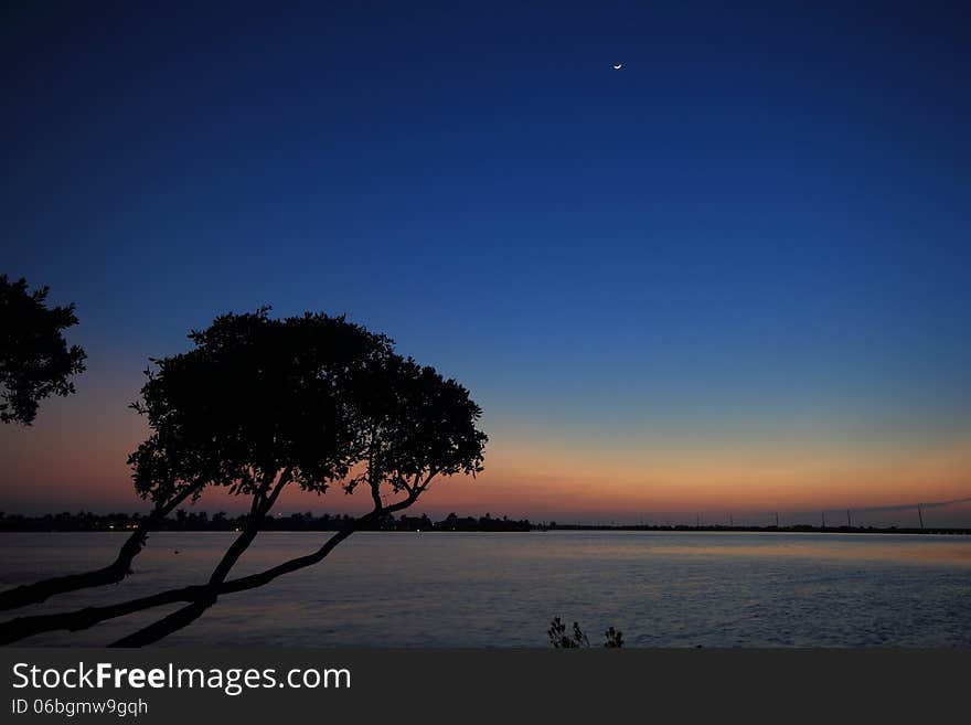 Looking out across the Keys in Florida just after sunset. The sky created brilliant colors grading from deep blue through to pink and a crescent moon also made an appearance. Looking out across the Keys in Florida just after sunset. The sky created brilliant colors grading from deep blue through to pink and a crescent moon also made an appearance.