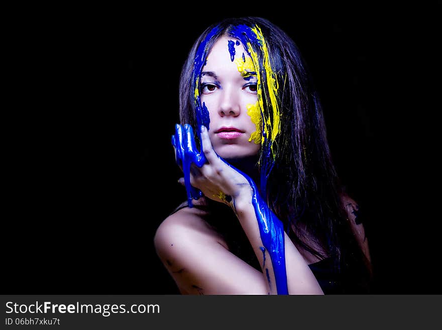 Beauty/fashion Close Up Portrait Of Woman Painted Blue And Yellow On Black Background