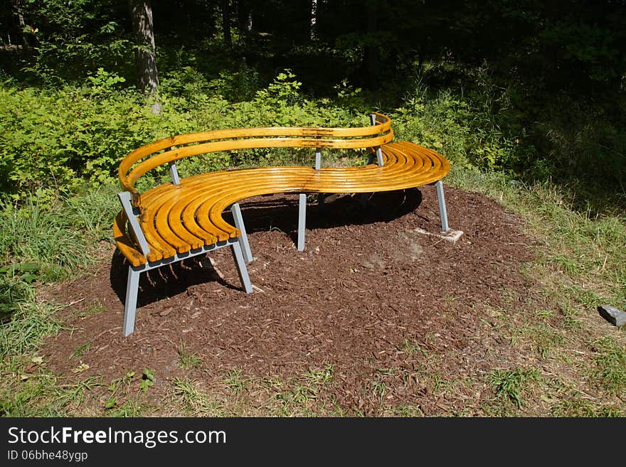 S-Shaped park bench in the woods