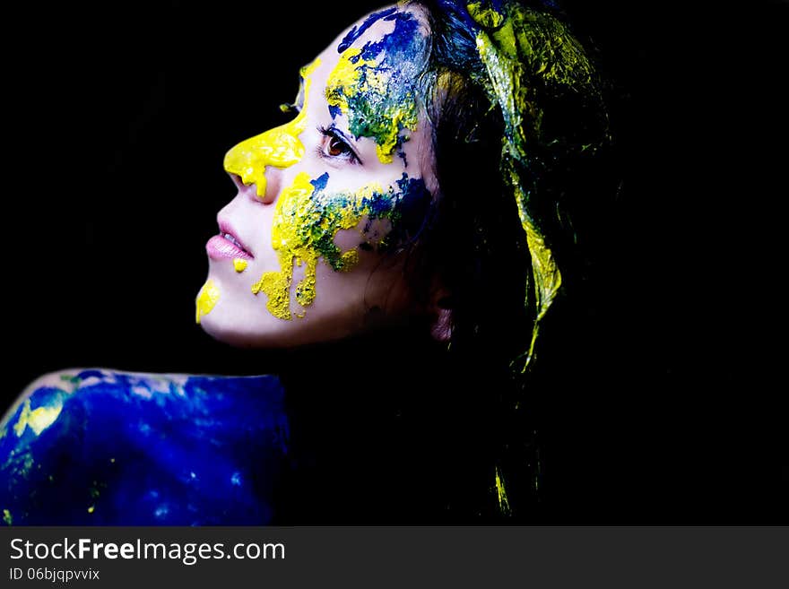 Beauty/fashion Close Up Portrait Of Woman Painted Blue And Yellow On Black Background