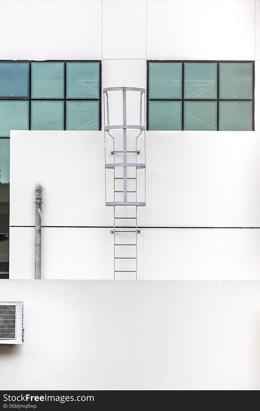 Steel ladder glass closed windows on a building