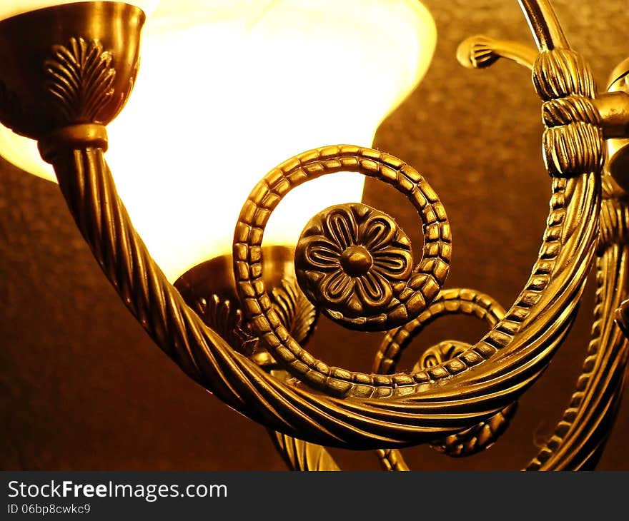 Curved bronze design on a hanging light