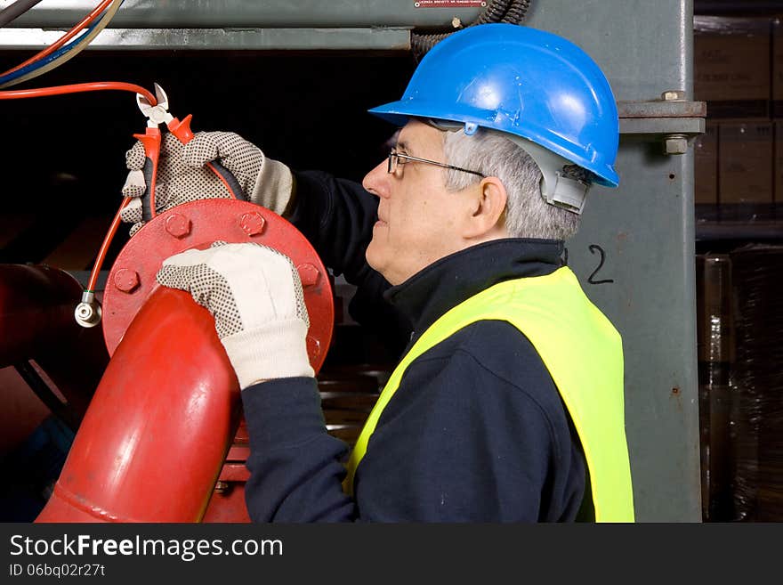 Maintenance worker at work with a machine