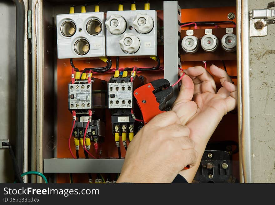 Electrician working in a plant to be fitted