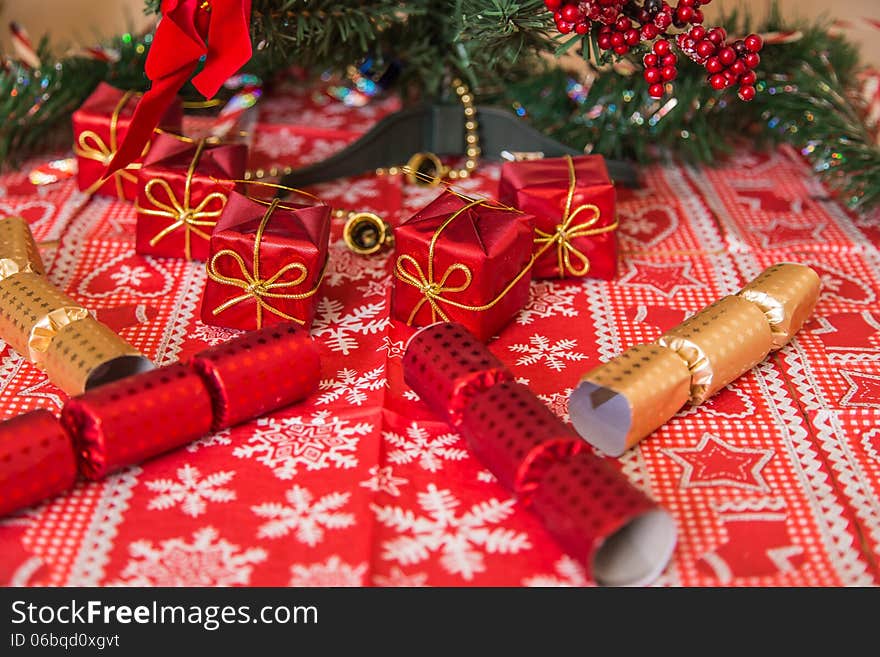 Various Christmas decor like gifts, ribbons, tinsel, crackers