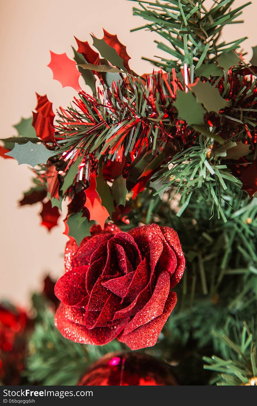 A Christmas Rose with tinsel and parts of a Christmas tree