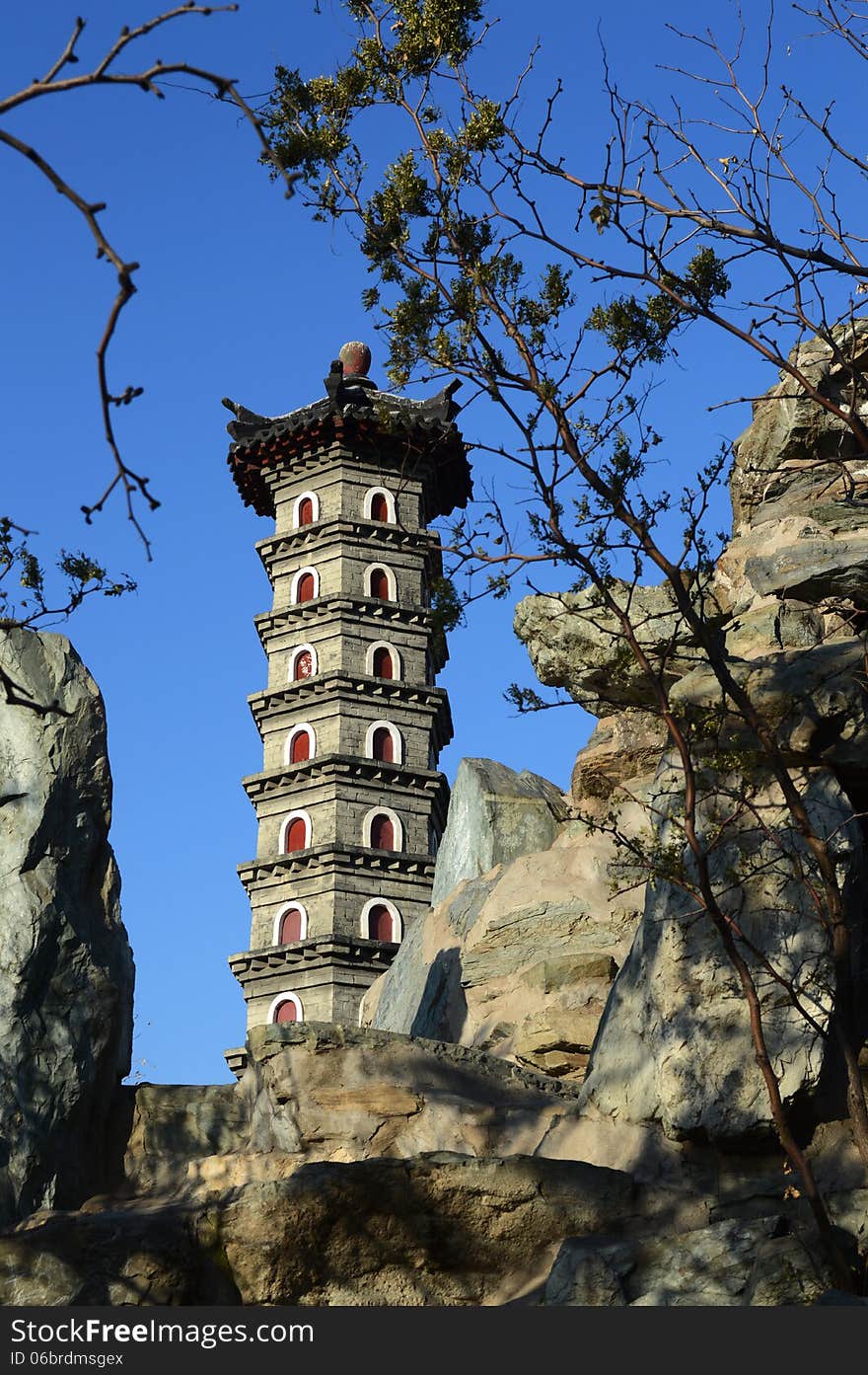 The China pagoda on the artificial hill with the blue sky. The China pagoda on the artificial hill with the blue sky