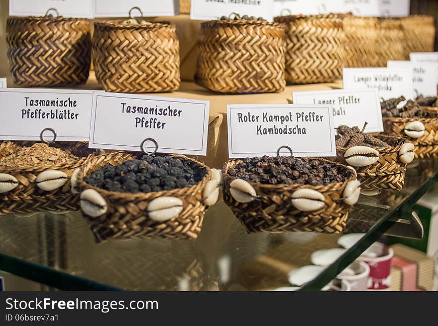 Spices in wattled basket with german witten on the white board