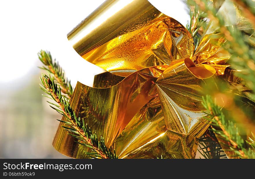 Close on glossy golden ribbon on a Christmas tree