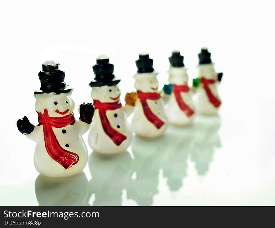 Row of small snowmen over a white background. Row of small snowmen over a white background