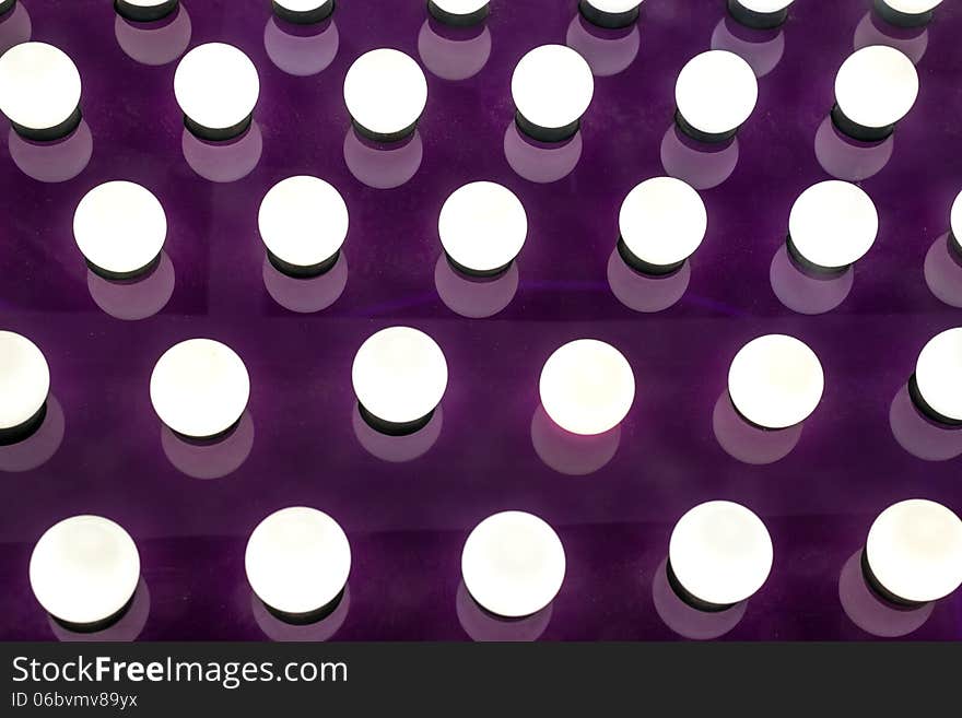 Many Round Illuminated Lights on Purple Board. Many Round Illuminated Lights on Purple Board