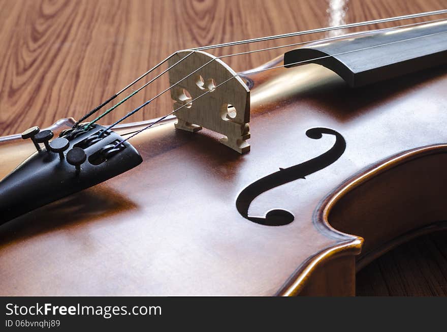 String instrument violin on wood background