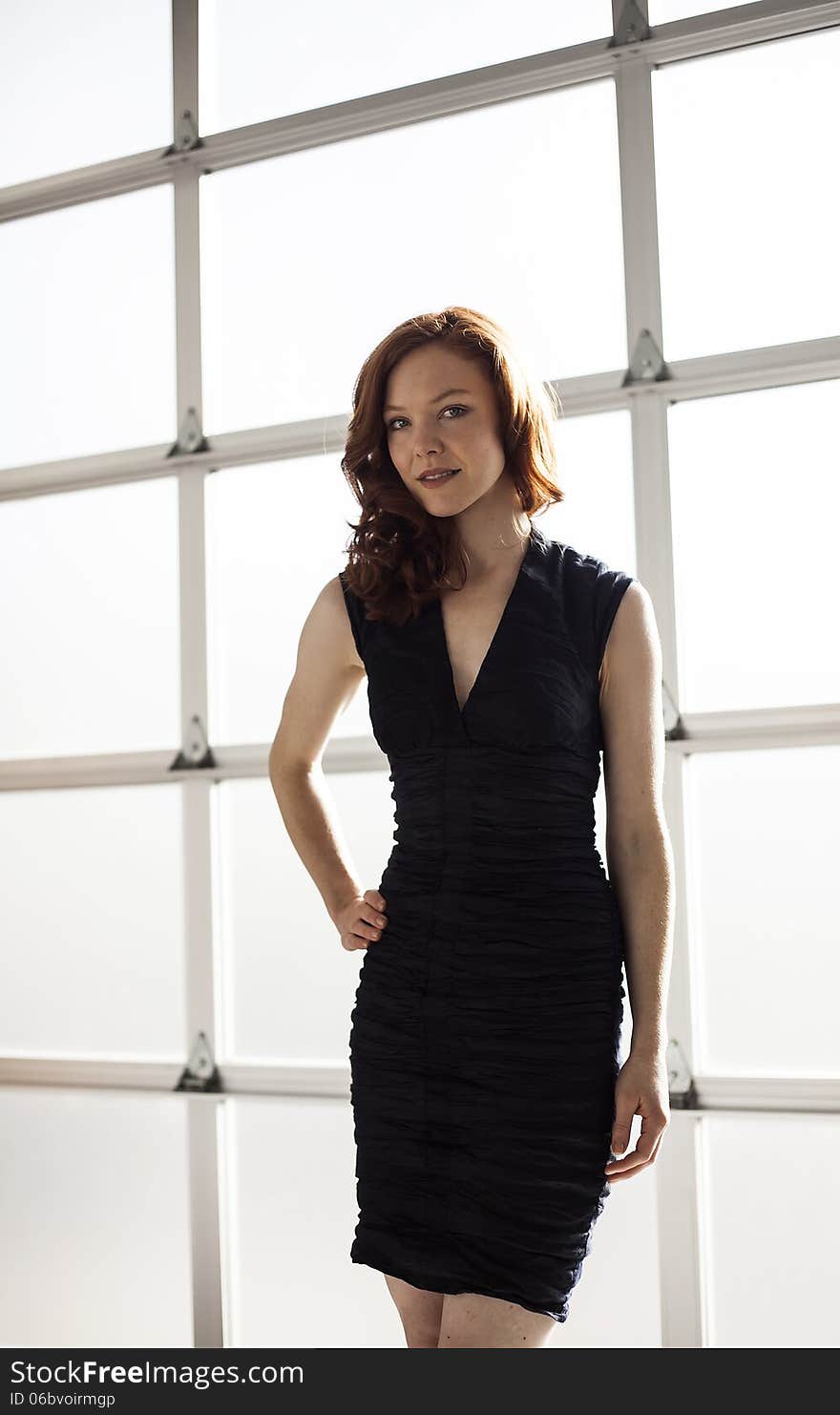 Portrait of a beautiful young woman with red hair and blue eyes. Portrait of a beautiful young woman with red hair and blue eyes.