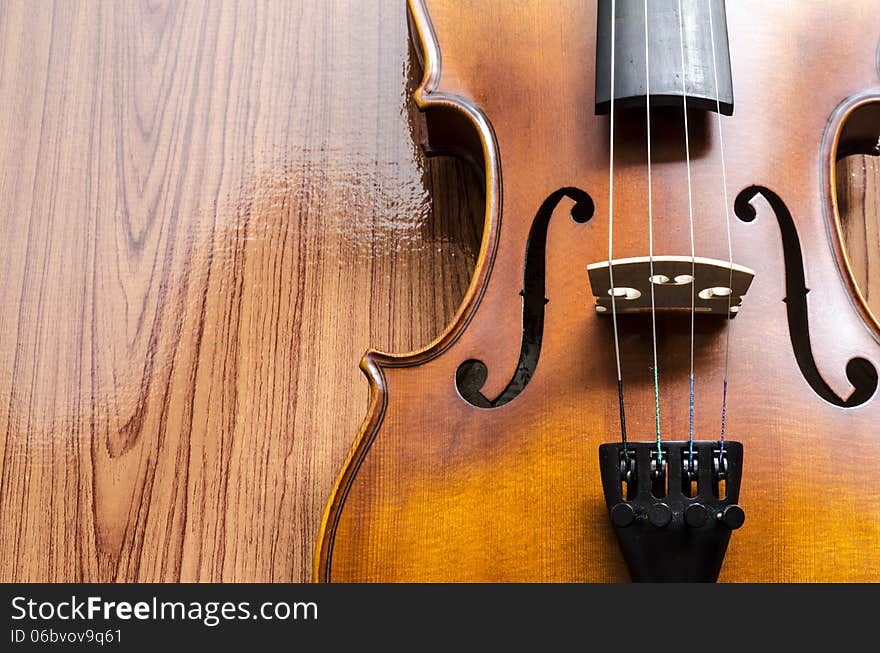 String instrument violin on wood background