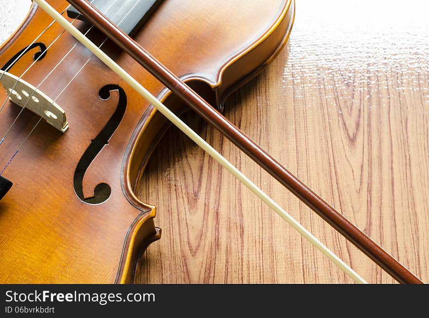 String instrument violin on wood background