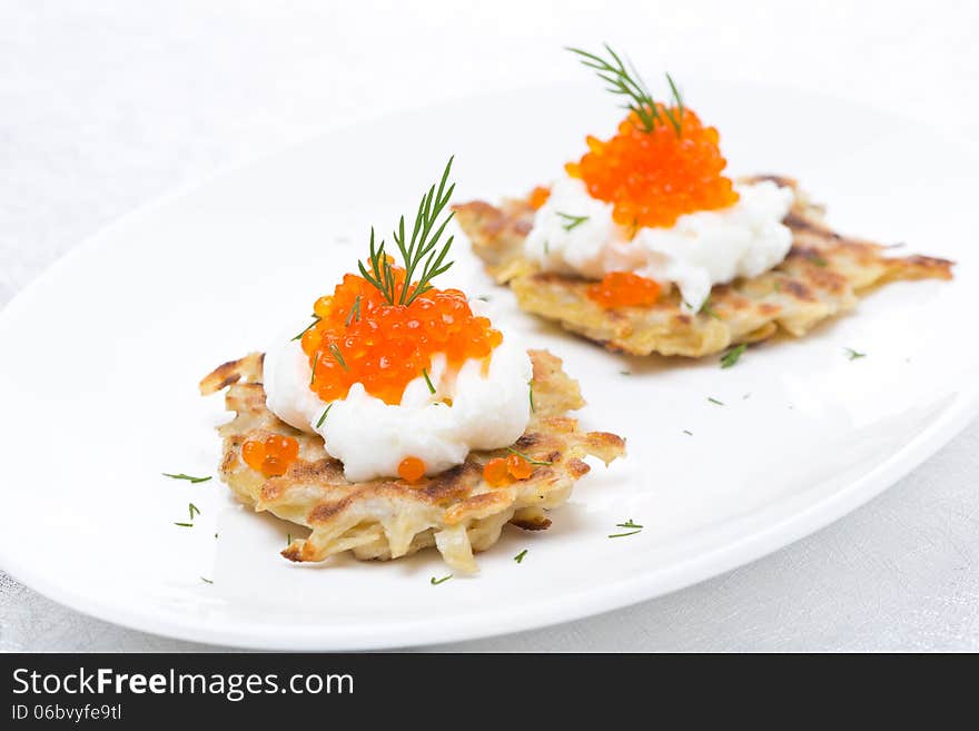 Potato pancakes with caviar, close-up, horizontal