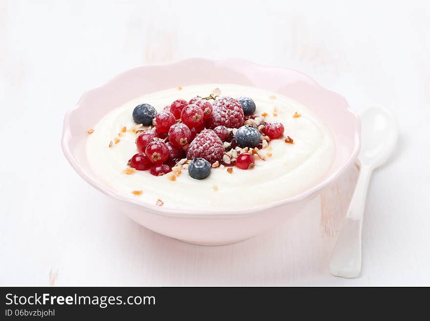 Semolina porridge with berries and nuts, horizontal, close-up