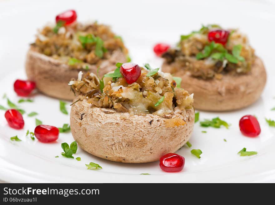 Stuffed mushrooms with herbs and pomegranate, close-up