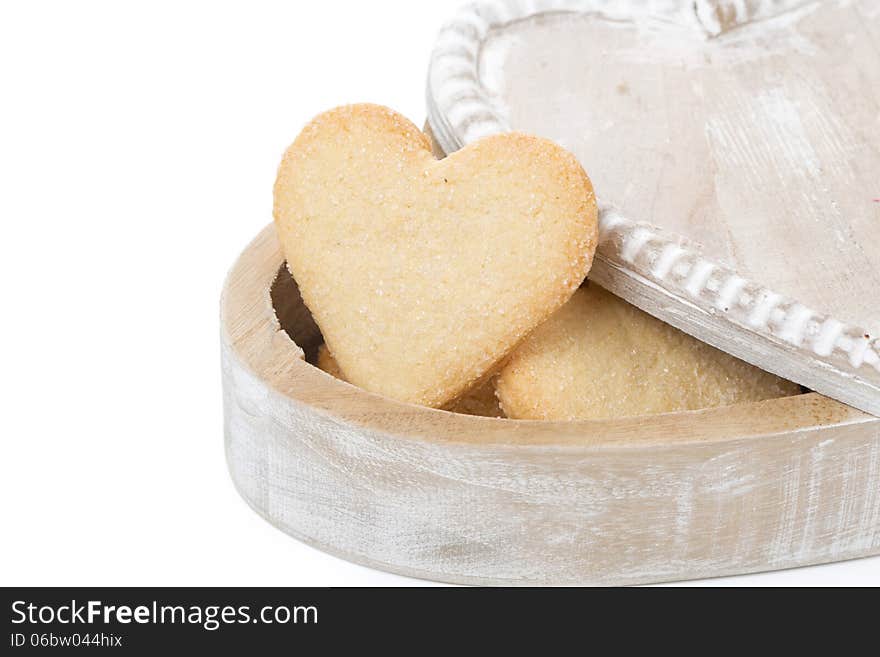 Wooden box with cookies in the form of heart, isolated