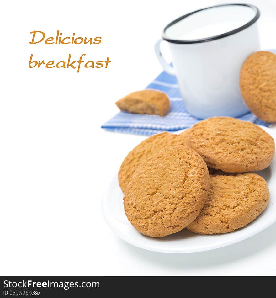 Plate of oatmeal cookies and mug of milk isolated on white, close-up