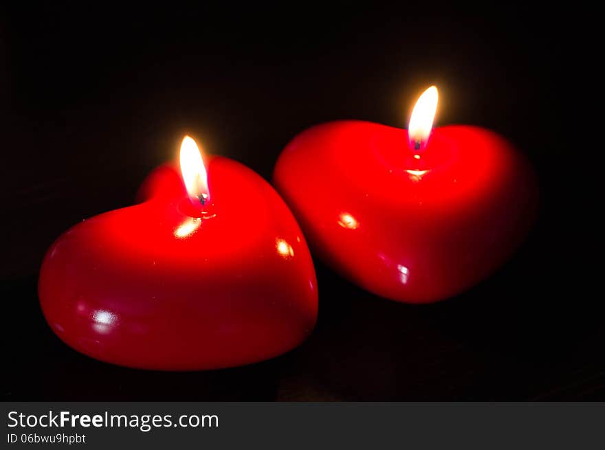 Two red candles in the form of heart