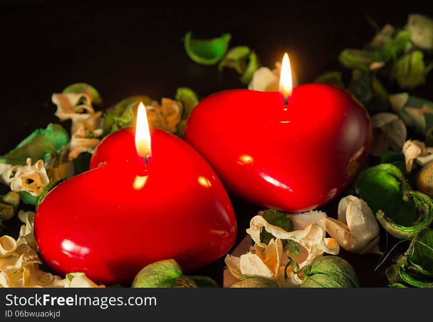 Couple Of Red Candles Among The Dried Flowers