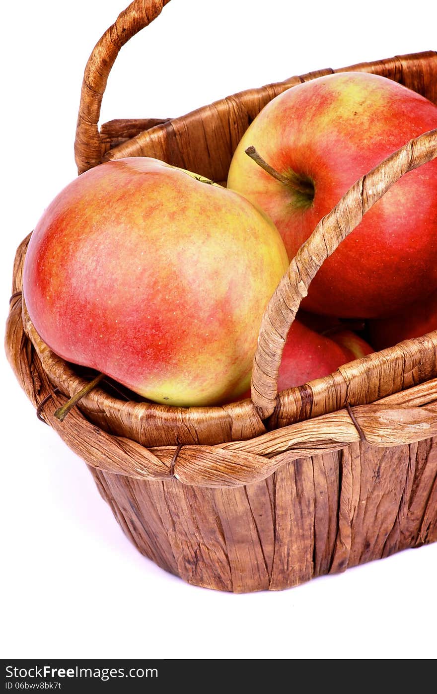 Delicious Ripe Red Apples in Wicker Basket closeup on white background. Delicious Ripe Red Apples in Wicker Basket closeup on white background